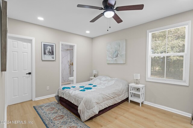 bedroom with ensuite bathroom, ceiling fan, and hardwood / wood-style flooring