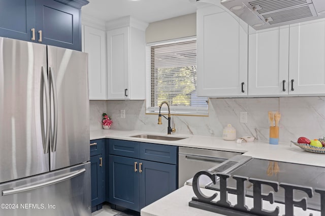 kitchen with appliances with stainless steel finishes, tasteful backsplash, exhaust hood, sink, and white cabinetry