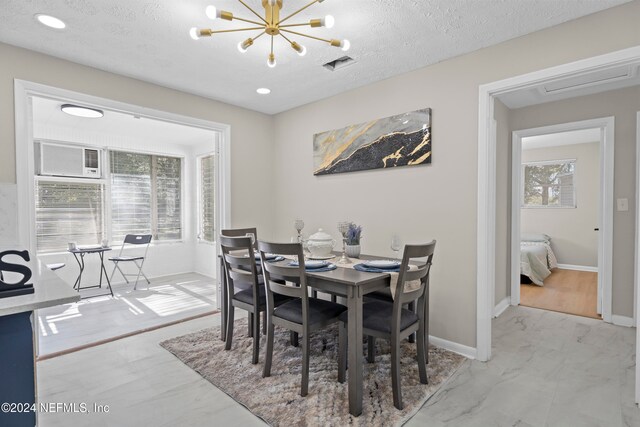 dining room featuring a textured ceiling and a chandelier