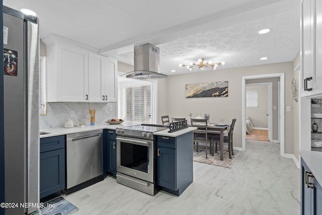 kitchen featuring blue cabinetry, appliances with stainless steel finishes, white cabinetry, kitchen peninsula, and island exhaust hood