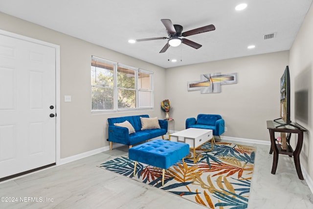 living area featuring ceiling fan