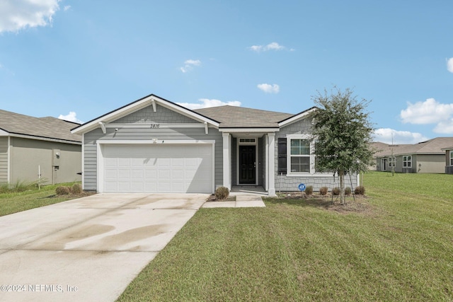 ranch-style house featuring a front yard and a garage