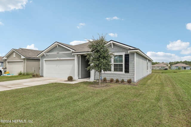 view of front of home with a garage and a front lawn