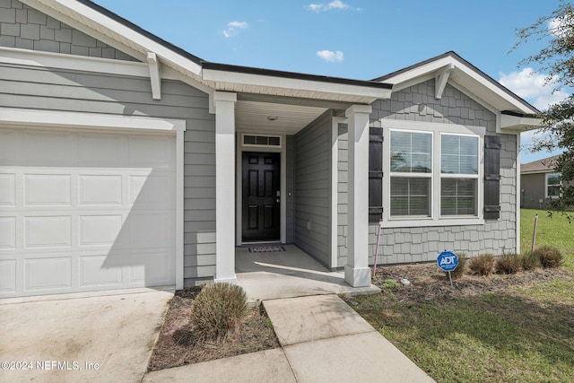 doorway to property with a garage