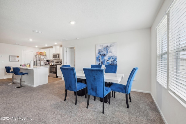 view of carpeted dining area