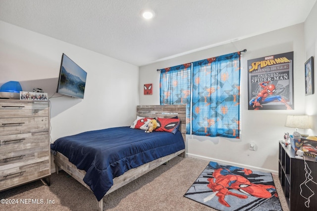 carpeted bedroom with a textured ceiling