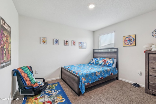 carpeted bedroom with a textured ceiling