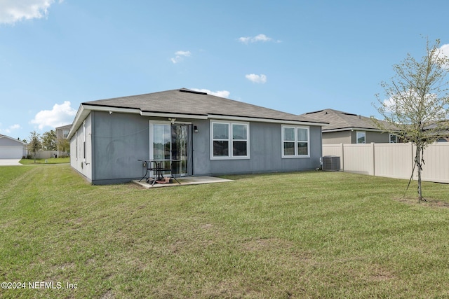 back of house with a yard, a patio, and central air condition unit