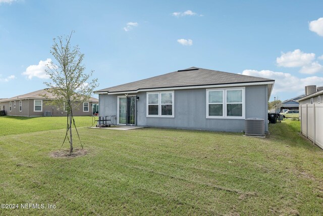 back of house with a yard and cooling unit