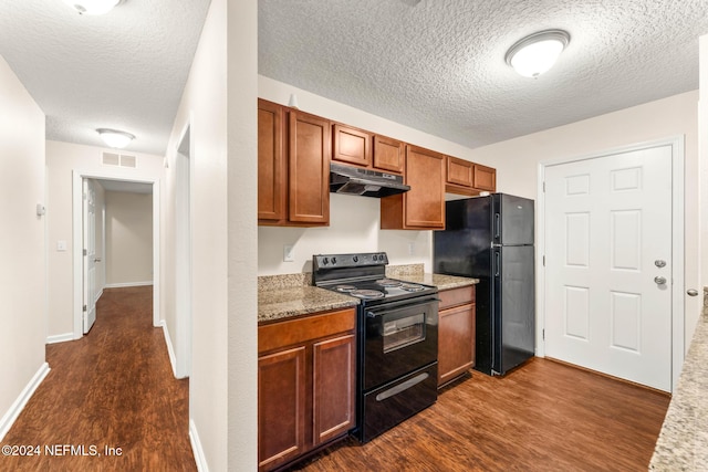 kitchen featuring black appliances, dark wood-type flooring, and a textured ceiling