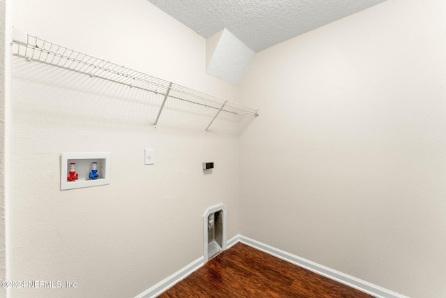 clothes washing area with hookup for a washing machine, dark wood-type flooring, and a textured ceiling