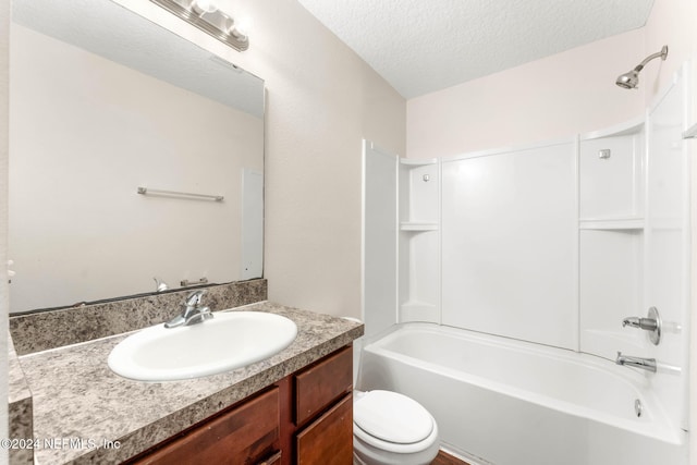 full bathroom featuring vanity, a textured ceiling, toilet, and  shower combination