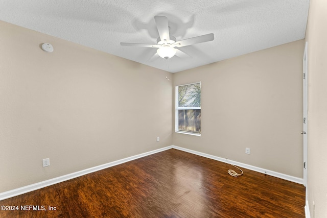 empty room featuring a textured ceiling, ceiling fan, and dark hardwood / wood-style floors