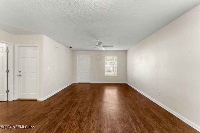 unfurnished room with dark hardwood / wood-style floors, ceiling fan, and a textured ceiling