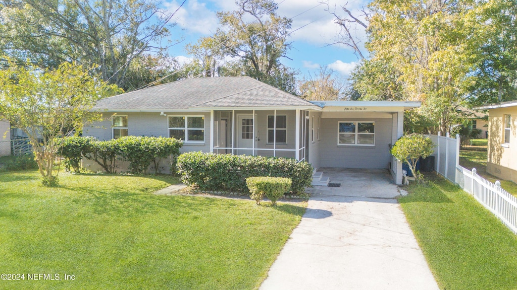 single story home featuring a front yard and a carport