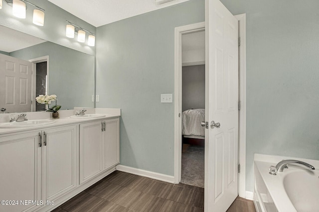 bathroom with vanity and a tub to relax in