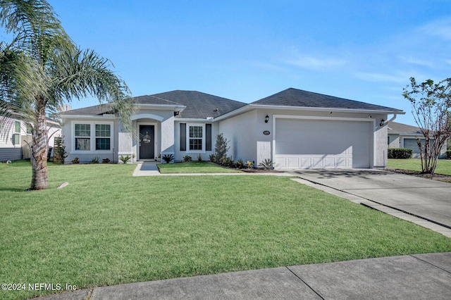 ranch-style house featuring a front yard and a garage