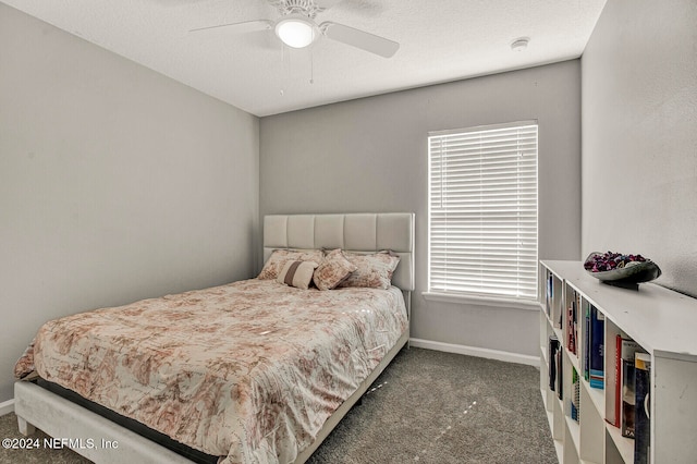 carpeted bedroom featuring ceiling fan and a textured ceiling