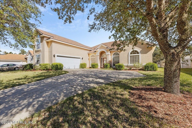 view of front of home featuring a garage and a front lawn