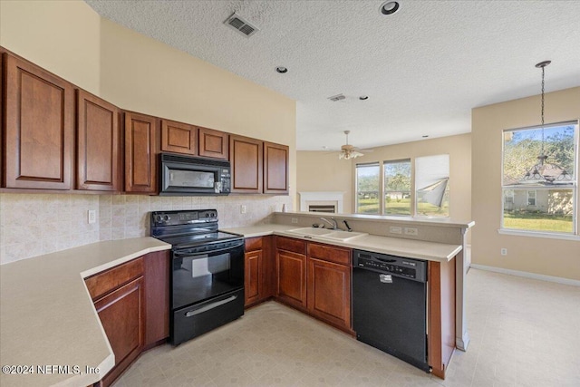 kitchen with kitchen peninsula, ceiling fan, sink, black appliances, and pendant lighting