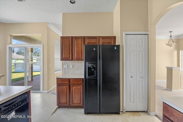 kitchen featuring black appliances, decorative light fixtures, crown molding, and a textured ceiling