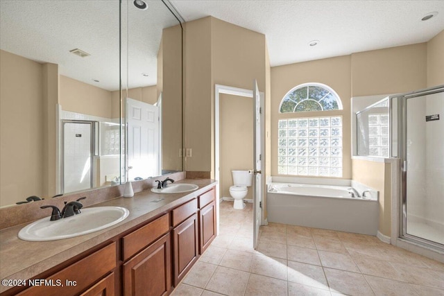 full bathroom featuring vanity, tile patterned flooring, toilet, a textured ceiling, and independent shower and bath