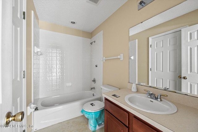 full bathroom with a textured ceiling, vanity, toilet, and tiled shower / bath