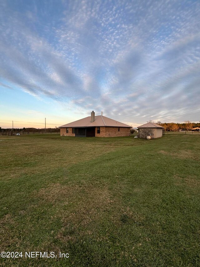 view of yard at dusk