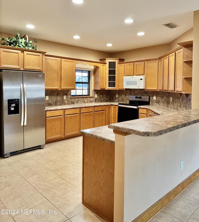 kitchen with light tile patterned floors, kitchen peninsula, backsplash, and appliances with stainless steel finishes