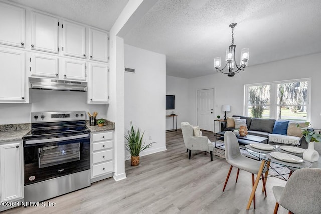 kitchen featuring stainless steel range with electric stovetop, white cabinets, hanging light fixtures, light hardwood / wood-style floors, and a chandelier