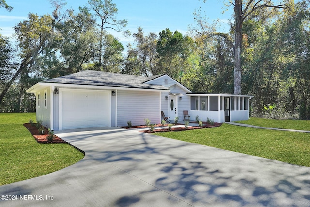 ranch-style home with a sunroom, a front yard, and a garage