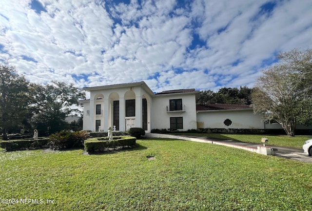 mediterranean / spanish home featuring a front yard