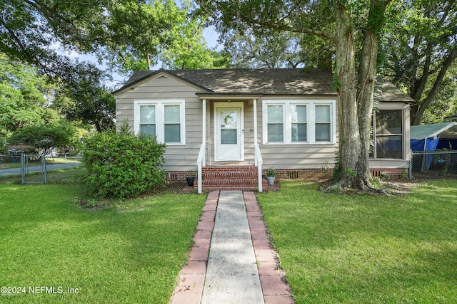 bungalow-style house featuring a front yard