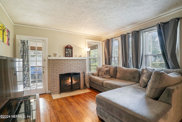 living room with wood-type flooring, a textured ceiling, and a wealth of natural light