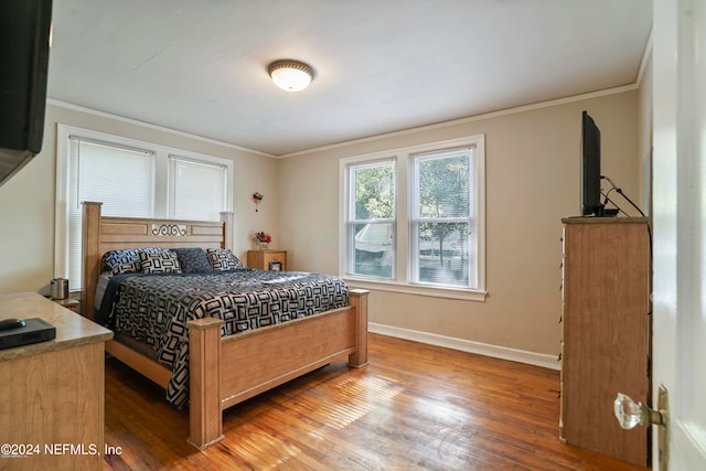 bedroom featuring hardwood / wood-style flooring and crown molding