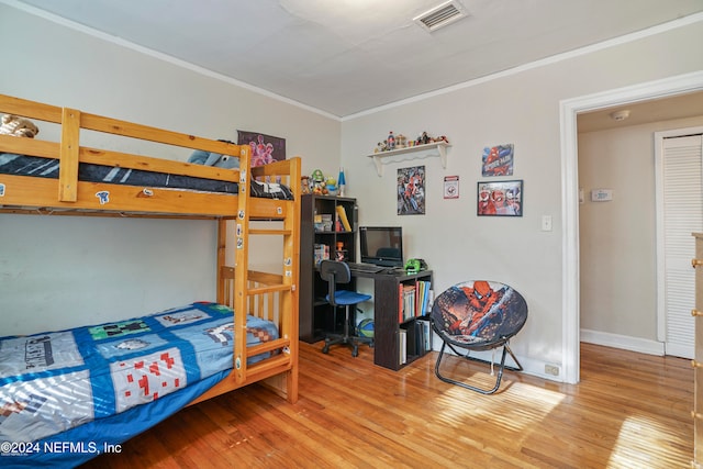 bedroom featuring light wood-type flooring and ornamental molding