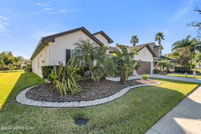 view of front facade with a front lawn and a garage