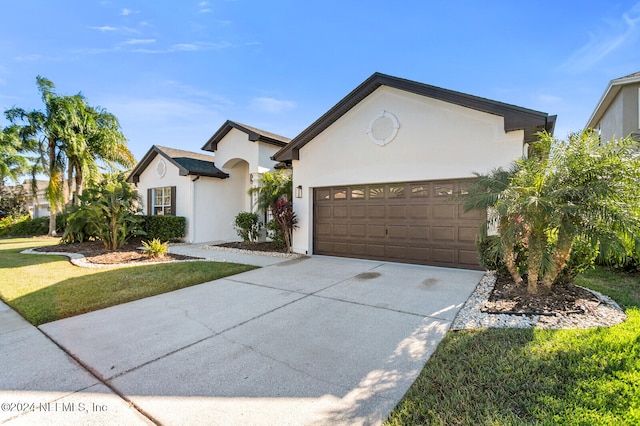 view of front of home featuring a garage and a front yard