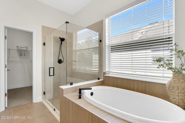 bathroom featuring tile patterned floors and separate shower and tub