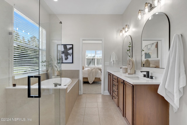 bathroom featuring tile patterned floors, vanity, a healthy amount of sunlight, and walk in shower