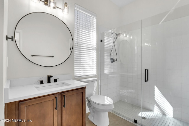 bathroom with toilet, vanity, tile patterned floors, and an enclosed shower