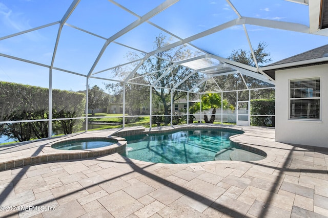 view of swimming pool with a lanai, an in ground hot tub, and a patio