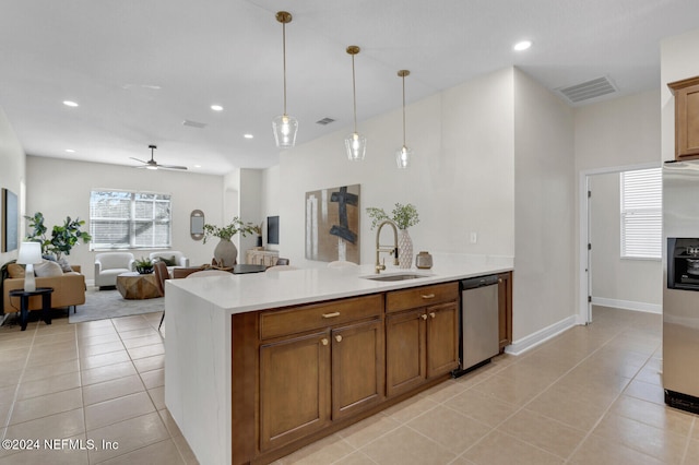 kitchen with appliances with stainless steel finishes, ceiling fan, sink, hanging light fixtures, and light tile patterned flooring