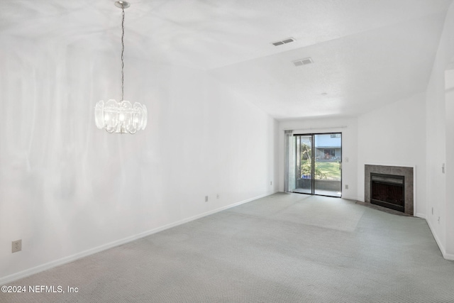 unfurnished living room featuring light colored carpet, vaulted ceiling, and an inviting chandelier