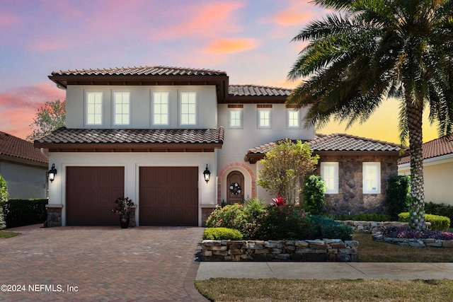 mediterranean / spanish-style house with a garage