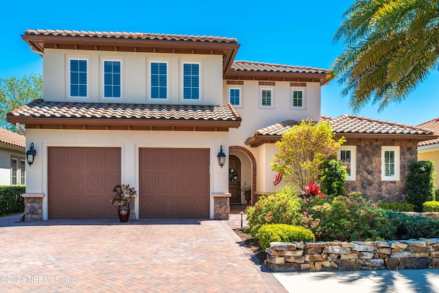 mediterranean / spanish home with a garage