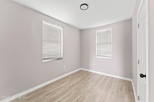 spare room featuring light hardwood / wood-style floors