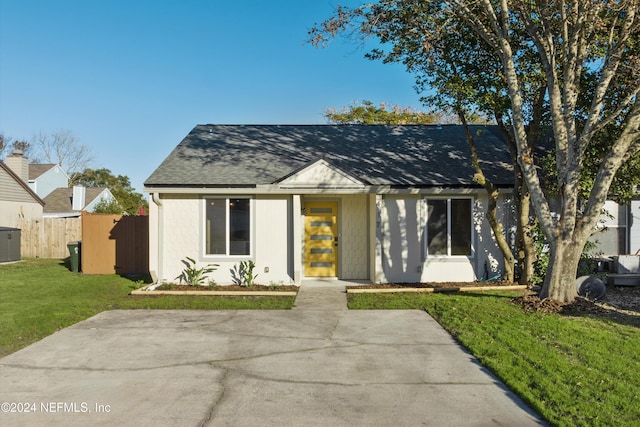 view of front of property featuring central AC and a front lawn