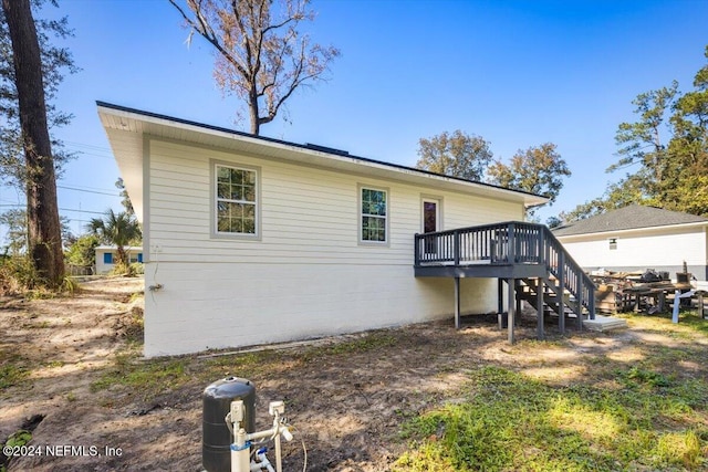 back of property featuring a wooden deck