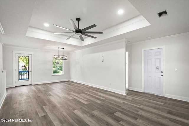 empty room featuring dark hardwood / wood-style floors, ornamental molding, a textured ceiling, and ceiling fan with notable chandelier